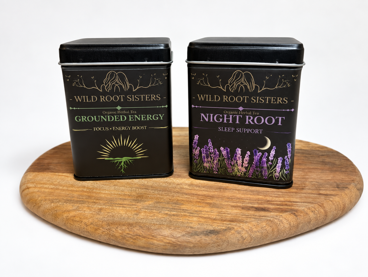 Grounded Energy and Night Root tea tins on a wooden board
