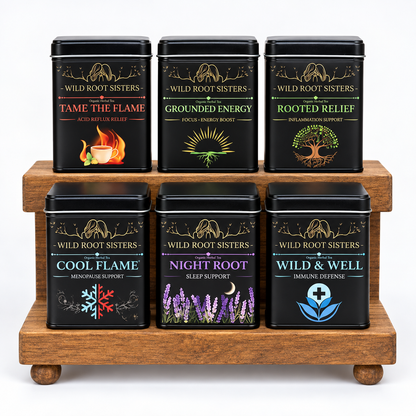 All six Wild Root Sisters herbal tea tins on a wooden display stand