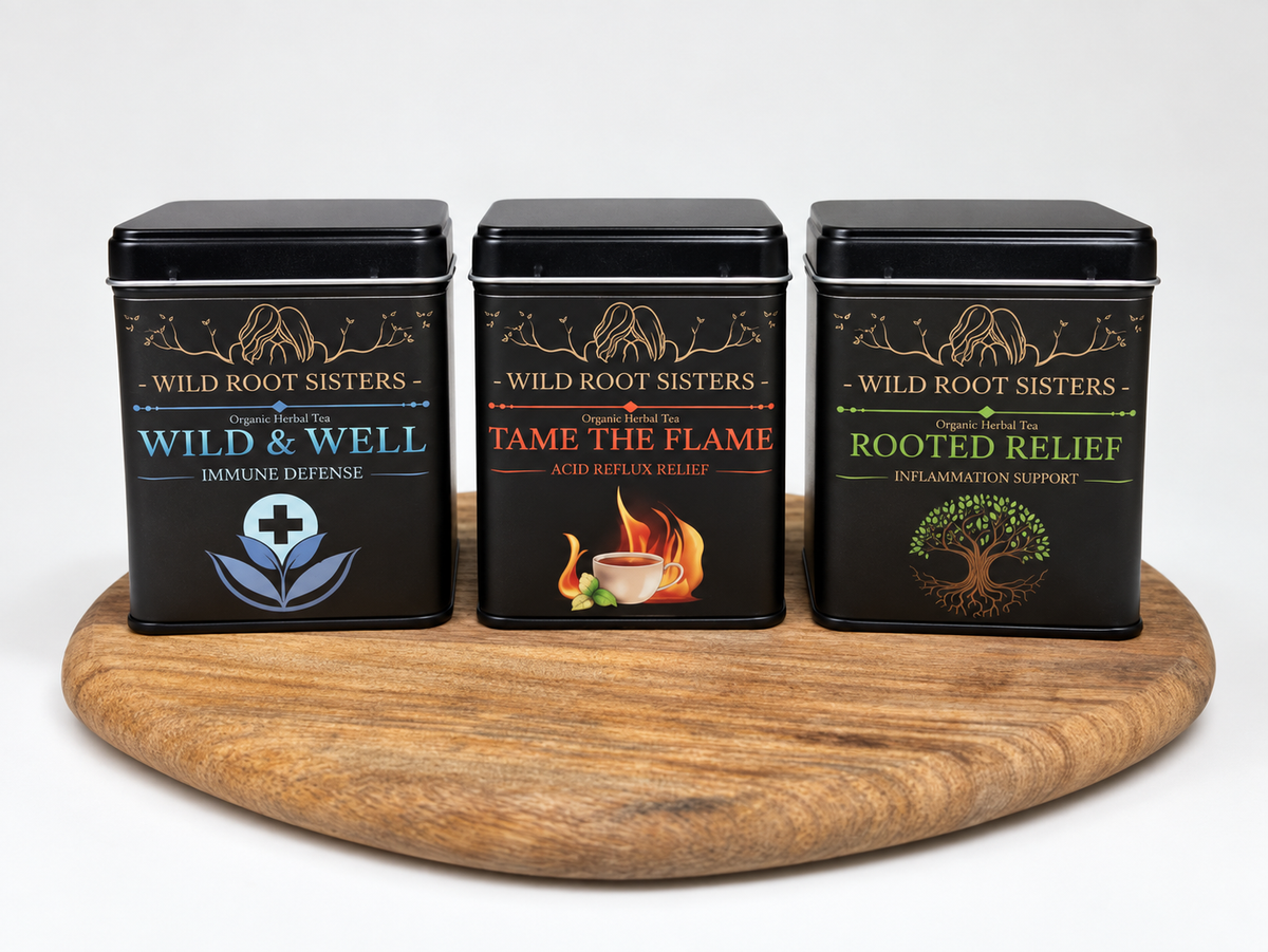 Wild &amp; Well, Tame the Flame and Rooted Relief tea tins on a wooden board